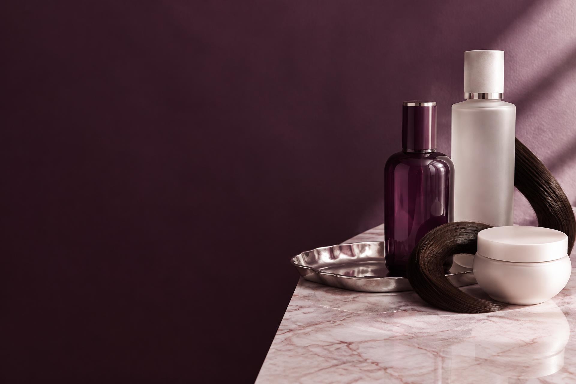 Unbranded beauty still life with sculptural bottles, porcelain and hair on marble